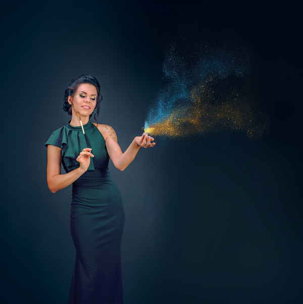 Professional picture of our Ukrainian sand artist for events posing with paintbrush and butterfly made of sand | Altus Entertainment